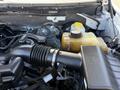 A close-up view of a 2014 Ford F-150 engine compartment showcasing the air intake and coolant reservoir