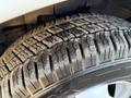 Close-up of a tire on a 2015 GMC Savana showing detailed tread patterns and a partially visible rim