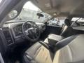 Interior of a 2012 RAM 2500 showing the steering wheel dashboard and driver seat with leather upholstery