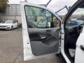 A 2019 Ford Transit Connect with the driver's side door open showing the interior and dashboard details