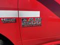 A close-up of a red 2015 RAM 2500 truck showing the badges for HEMI 5.7 liter and RAM 2500 Heavy Duty