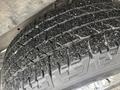 Close-up of a treaded tire from a 2022 GMC Savana showing detailed grooves and patterns on the surface