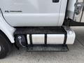 A 2019 Ford F-750 with a large silver fuel tank and black step board located below the driver's door