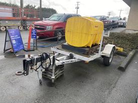 A 2014 Express 8 Foot Trailer with a yellow water tank mounted on it is parked and equipped with a hitch and wheel chocks