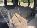 The interior of a 2021 Chevrolet Express showing gray leather seats with seatbelts and a clean design