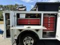 A 2020 Ram 2500 truck with an open utility bed featuring red tool drawers and a work surface attached to the side