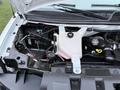 The image shows the engine compartment of a 2016 GMC Savana with visible components including the coolant reservoir and various wires and hoses