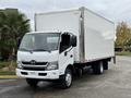 A 2019 Hino 195 box truck with a white exterior and a metal cargo area mounted on a chassis with a single rear axle