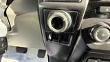 A close-up view of the dashboard controls and center console of a 2016 Ford F-150 showing a power outlet and climate control dials