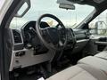 Interior view of a 2018 Ford F-550 showing the dashboard steering wheel and gear shift with gray upholstery on seats and controls visible