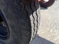 A close-up of a tire showcasing its tread pattern and details on a 2021 Wallenstein Wx540-0RA tow-behind industrial log splitter