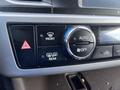 Control panel of a 2018 Toyota Highlander featuring buttons for front and rear defrost settings along with an auto climate control knob
