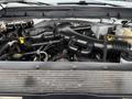 Engine compartment of a 2016 Ford F-550 Super Duty showcasing various components including the engine, hoses, and fluid reservoirs