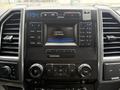 Dashboard of a 2018 Ford F-550 featuring controls for audio and climate settings a touchscreen display and various buttons and dials