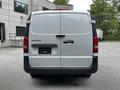 A rear view of a 2020 Mercedes-Benz Metris with a silver body and black trim showing the tailgate and taillights