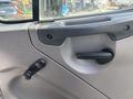 Interior door panel of a 2014 Freightliner M2 106 featuring a handle and a window control lever