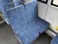 Two blue bus seats with a geometric pattern featuring small crosses and circles, designed for public transportation seating in a 2016 Grande West Vicinity bus
