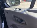 Close-up of the door panel of a 2025 Ford Transit T-350 showing the handle and window controls