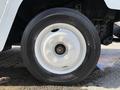 Close-up of a white rim and tire on a 2017 Freightliner MT45 showing detailed tread and wheel design