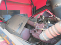 A 2013 Toro Grounds Master 5910 engine compartment showcasing components like the engine, exhaust system, and air intake with visible mechanical details