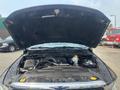 A 2015 RAM 1500 with its hood open revealing the engine and components including battery coolant reservoir and various hoses