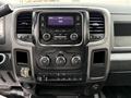 Dashboard of a 2013 RAM 3500 featuring a touchscreen stereo system with radio and media controls below along with various dials and buttons for climate and audio settings