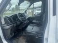 Interior view of a 2024 Ford Transit showing the driver's seat steering wheel and control panel