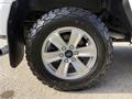 Close-up of a 2018 Ford F-150 wheel featuring a silver alloy rim and a rugged Goodyear tire with a distinctive tread pattern