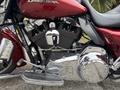Close-up of a 2009 Harley-Davidson Road King motorcycle engine showcasing chrome details and a black striped cylinder head