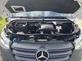 The engine compartment of a 2020 Mercedes-Benz Sprinter 2500 showcasing the engine components and various fluids in reservoirs