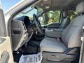 Interior view of a 2017 Ford F-550 showcasing the driver's seat dashboard and center console with gray fabric upholstery
