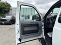 A 2013 Ford F-250 SD with the driver's side door open showcasing the interior door panel and controls