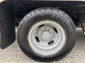 Close-up of a silver wheel on a 2014 Ford E-350 with a Nexen tire showing tread patterns and wheel lug nuts