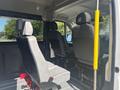 Interior view of a 2022 RAM Promaster 350 showing two front seats and a divider post with a yellow grip handle