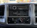 Dashboard controls of a 2015 Hino 358 including a radio unit and various climate and mirror adjustment knobs
