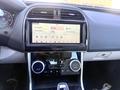Dashboard of a 2020 Jaguar XE featuring a central infotainment screen with navigation and media options along with climate control knobs and a gear shifter