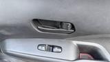 Interior door panel of a 2019 Nissan Kicks featuring a door handle and window controls
