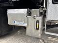 A silver control box labeled Certified Cirrus Control Systems mounted on the side of a 2016 RAM 5500 truck with a clear liquid level gauge attached