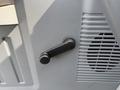 A black lever on the interior panel of a Ford F-350 SD designed for adjusting various functions related to vehicle operation