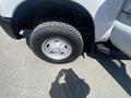 A close-up of the front wheel of a 2016 Ford F-350 SD showcasing the tire and chrome wheel rim