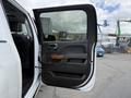 A 2017 Chevrolet Silverado 1500 door is open showing the interior handle and wood trim detail