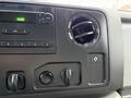 Interior dashboard of a 2019 Ford Econoline featuring audio controls air vent and climate control knobs
