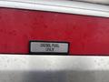 A metal label stating DIESEL FUEL ONLY mounted on the red and silver body of a 2006 E-One Typhoon vehicle