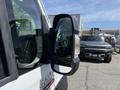 A 2021 RAM Promaster van with a close-up view of its side mirror and door handle