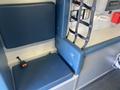 A 2011 Chevrolet Express with blue vinyl upholstery and a seatbelt system positioned in a vehicle interior