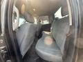 Interior of a 2015 RAM 1500 showing the backseat area with cloth seats and a center console