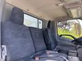 Interior of a 2018 Hino 195 showing two cloth-covered seats with seat belts and a visible dashboard on the right side