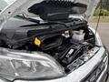 The engine compartment of a 2023 RAM Promaster 3500 showcasing various components like the engine cover coolant reservoir and air intake system