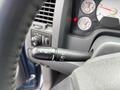 A close-up of the control stalk in a 2006 Dodge Ram 2500 displaying various functions like wipers and lights