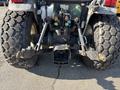 The rear view of a 2010 New Holland T4050 tractor showcasing its large tires and hydraulic system connections